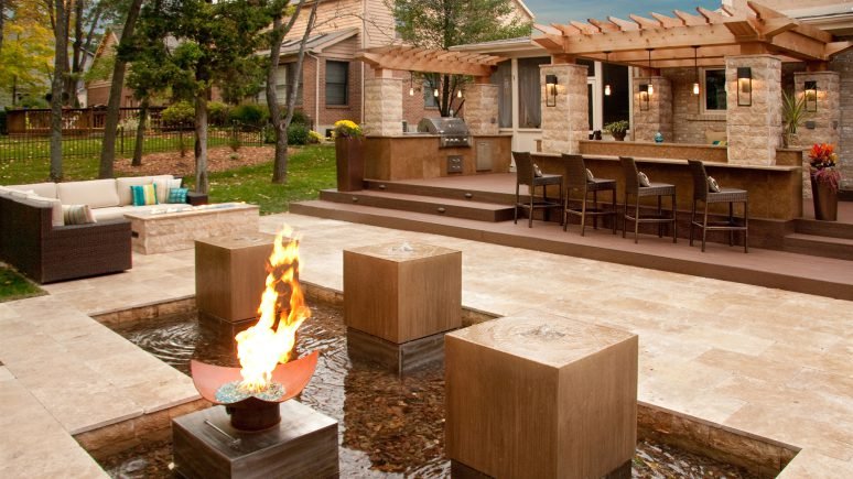 tandoori travertine backyard entertainment area with water feature