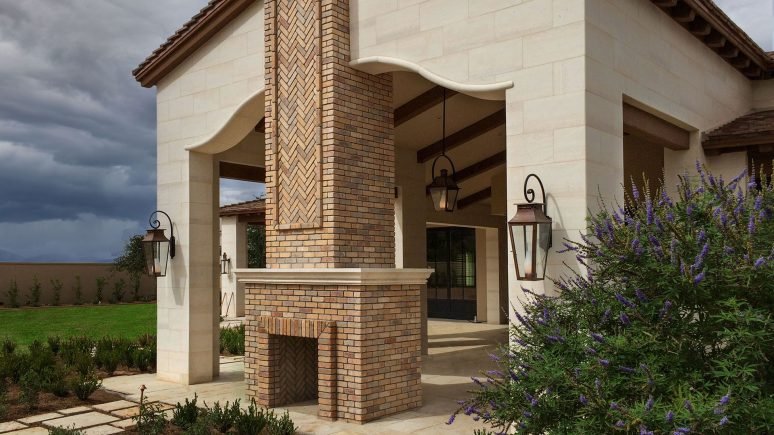 Stella Neo Planks natural stone thin veneer installed on exterior walls of homes outdoor area with fireplace