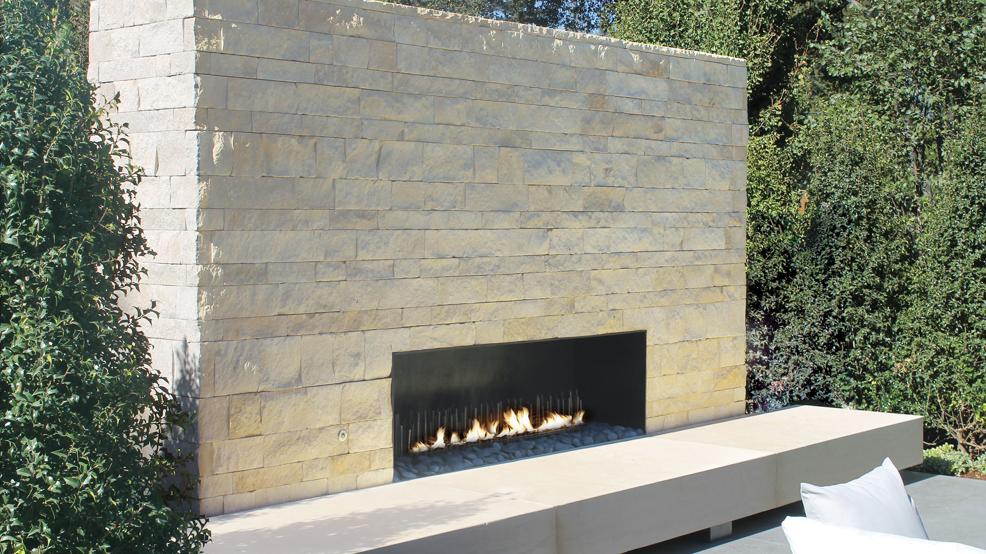 Nadia Pillowed Ledge natural stone thin veneer install on outdoor fireplace