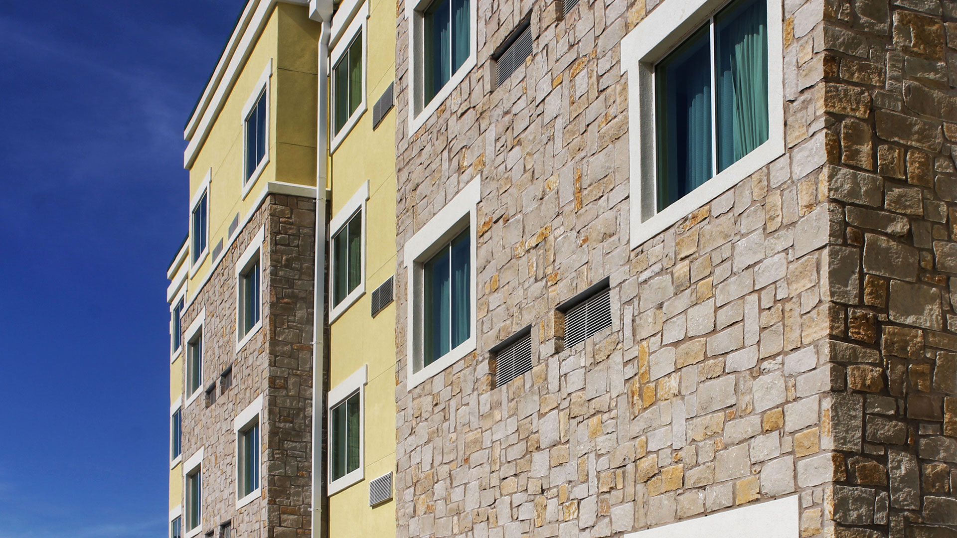 multi-family residential building with honey buff thin veneer installed on exterior walls