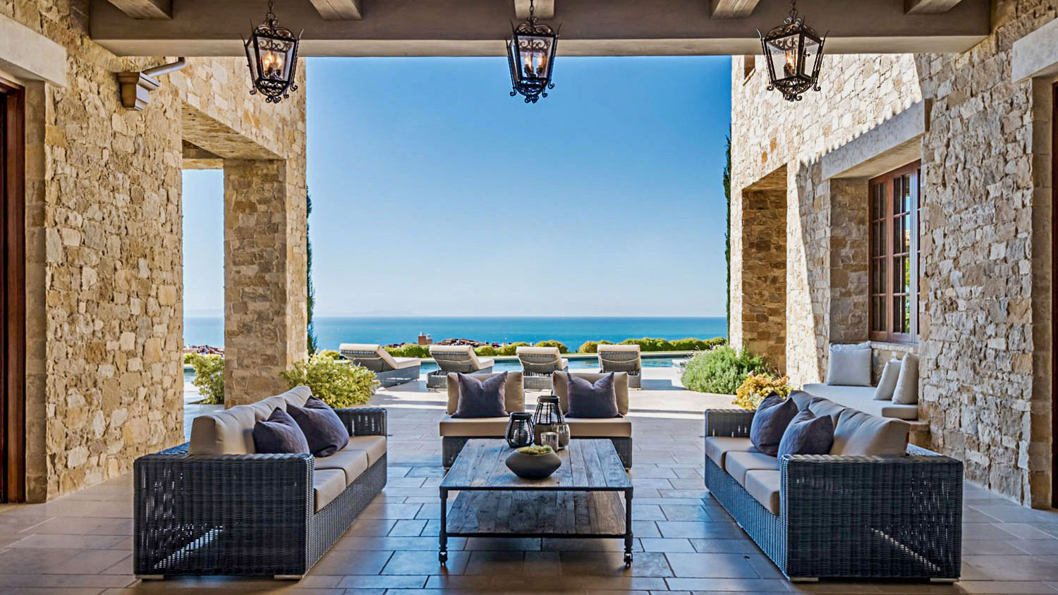 exterior seating area with ocean view Tuscan Blend Rubble thin veneer installed on exterior walls
