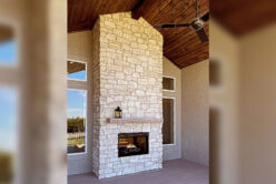 Tundra Cream Rubble natural stone thin veneer installed on fireplace.