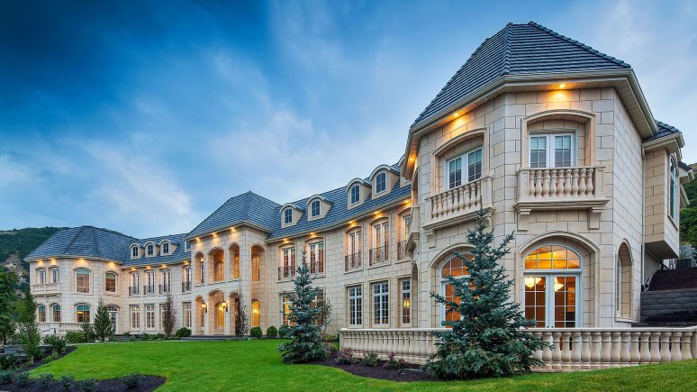 custom build home with cream custom architectural cut stone installed on exterior of home.