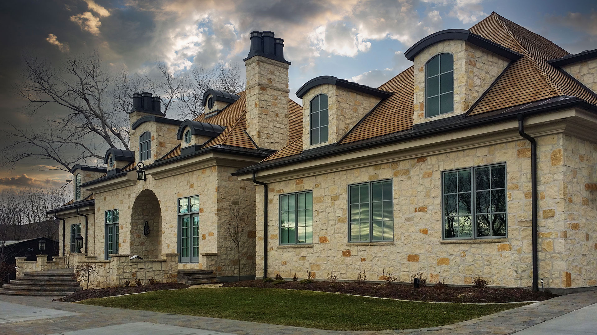 front of home with Sunflower Blend rubble custom profile natural stone thin veneer installed on exterior walls.