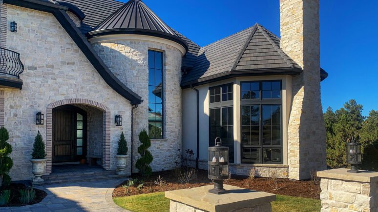 Tundra Cream Rubble natural stone thin veneer installed on exterior of custom home.