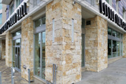 Montgomery Gold Traditional natural stone thin veneer installed on exterior wall of commercial business.
